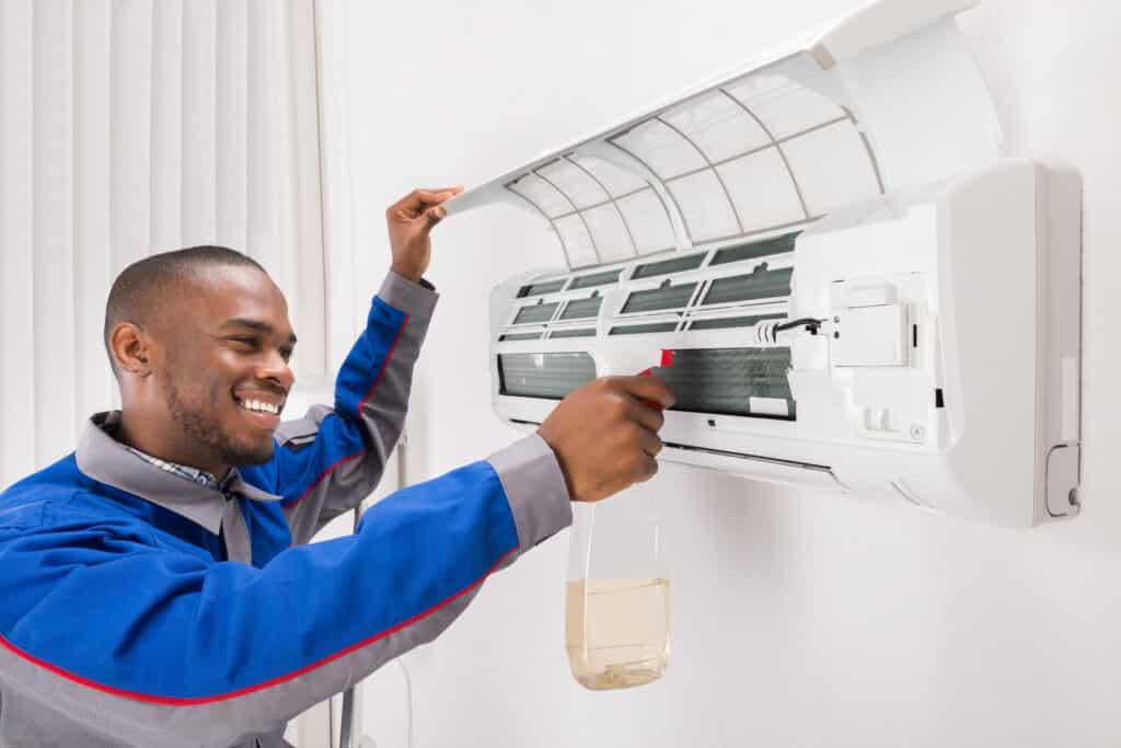 Technician Cleaning Air Conditioner